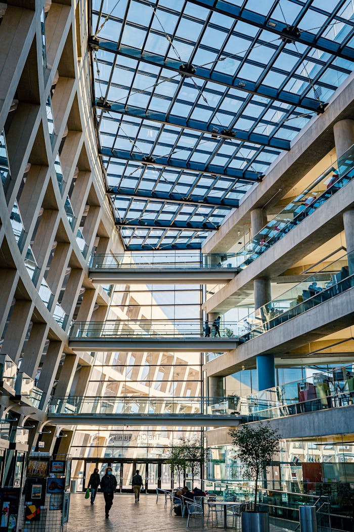 home-services-02 Contemporary shopping mall interior featuring a glass ceiling and multiple floors, emphasizing modern architecture.