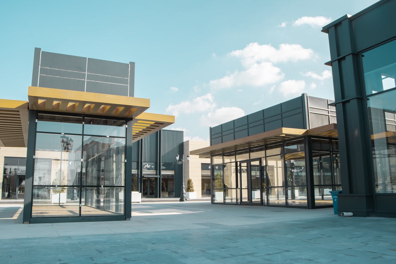 about-01 Empty modern urban space with glass facades under a clear sky.